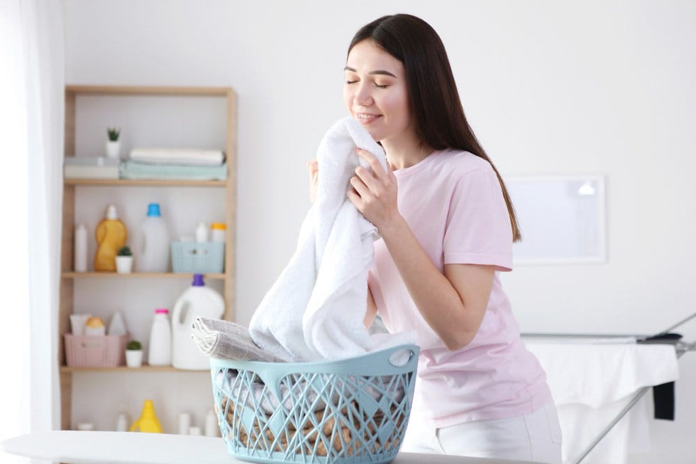 Woman holding freshly washed soft fabric for sensitive skin comfort