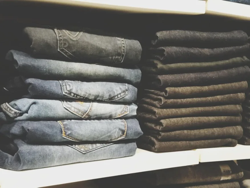 Close-up of stacked denim jeans