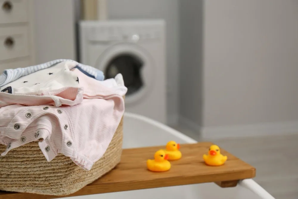 Baby clothes being gently washed and cared for, showing proper fabric maintenance techniques