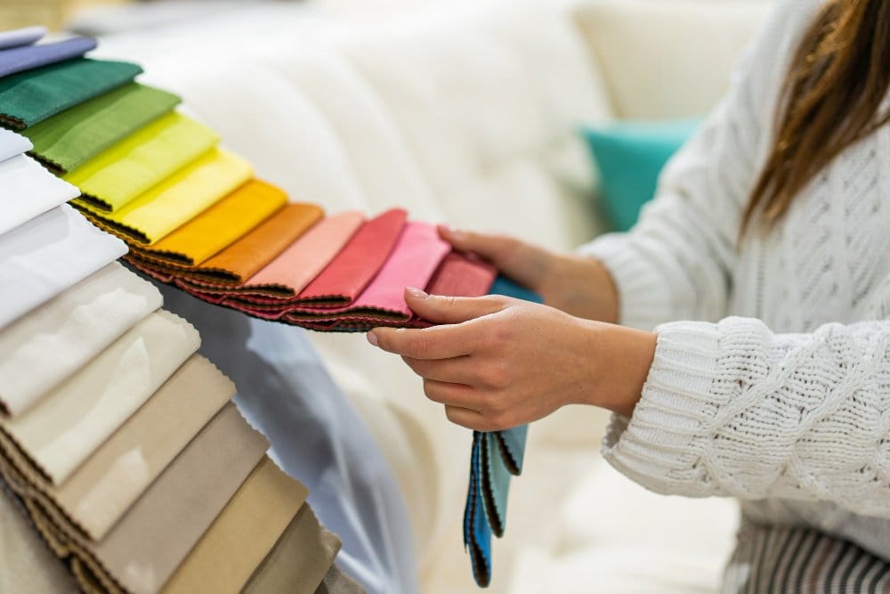Colorful fabric swatches arranged in gradient for textile reference