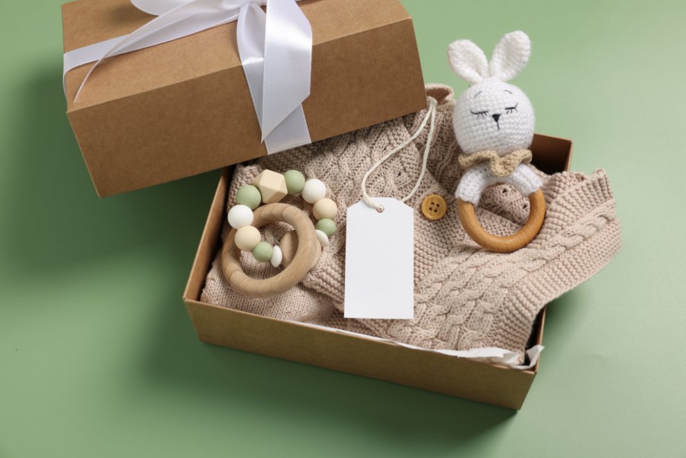 Beautifully wrapped baby clothing gifts showing appropriate sizes and thoughtful presentation