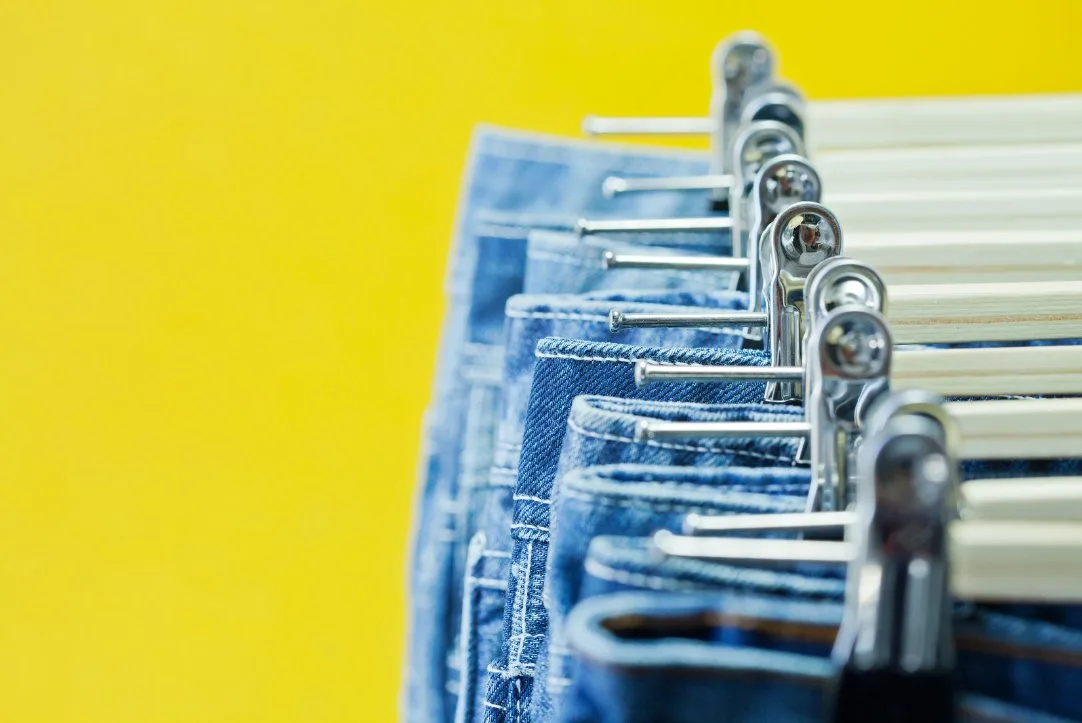 Organized closet showing an ideal collection of different jean styles and washes