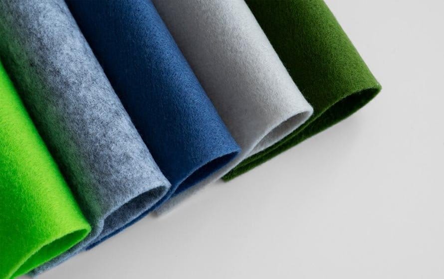 Colorful non woven felt fabric sheets in green, blue, and gray