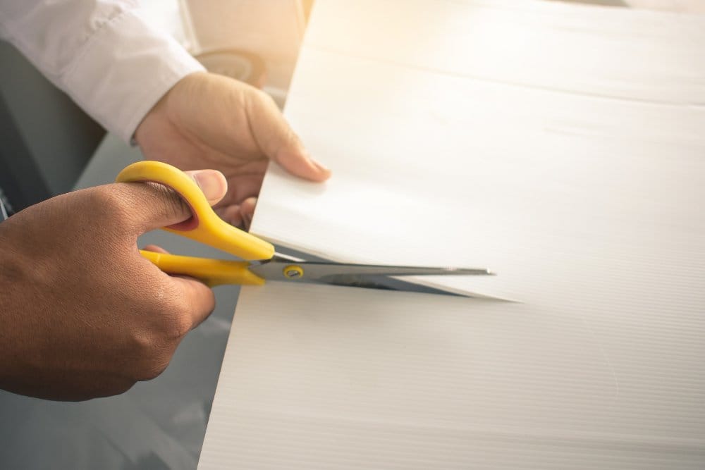 Cutting practice material with scissors before starting a sewing project