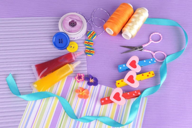 colorful sewing craft supplies including buttons thread scissors and ribbons for kids projects