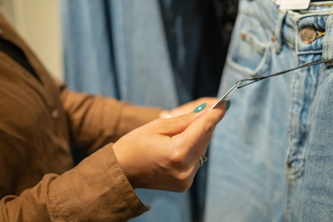 Woman shopping for jeans using smart strategies and measuring techniques