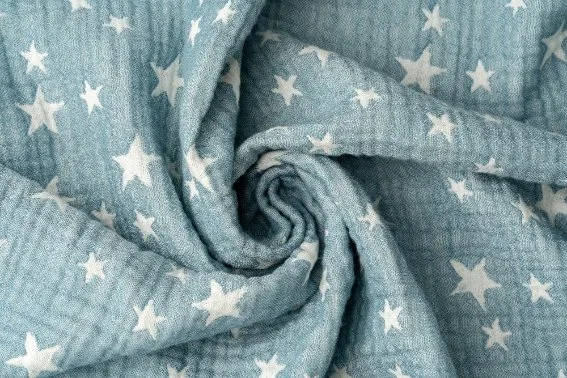 Close-up view of specialized baby fabrics including jersey knit, muslin, and bamboo materials