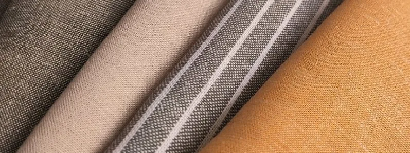 close-up of woven fabric showing interlaced warp and weft threads in a plain weave structure