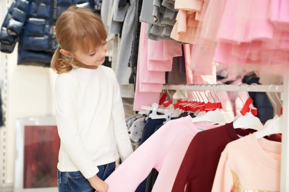little girl doing clothes shopping