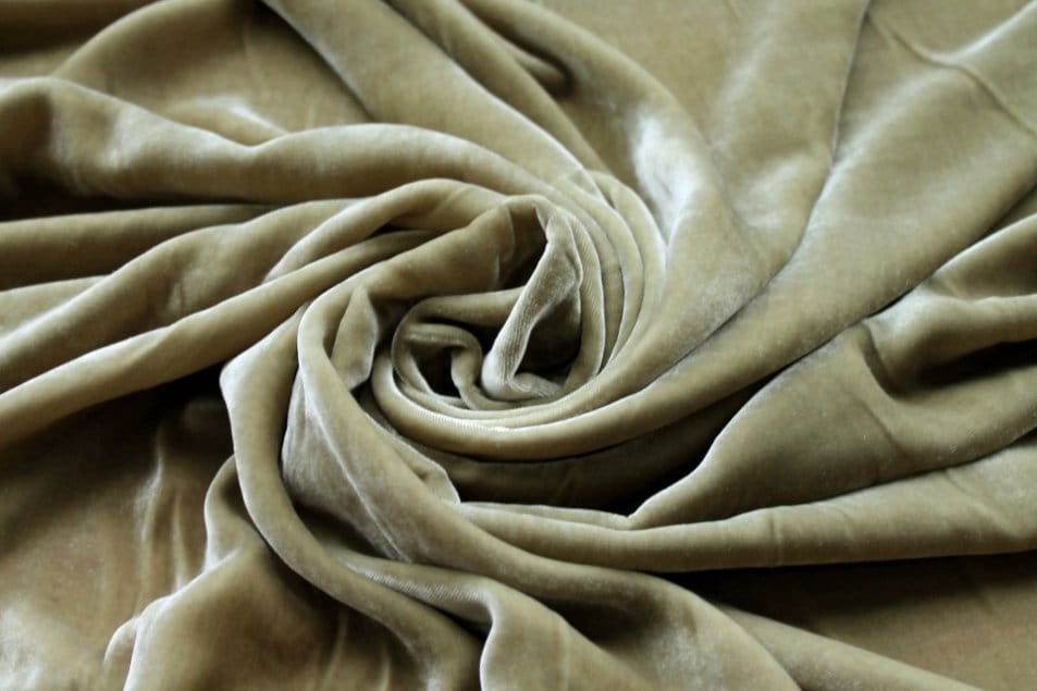 Olive green velvet fabric with plush pile and rich soft texture