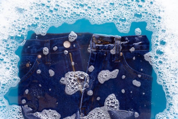 blue denim dipped in water being washed