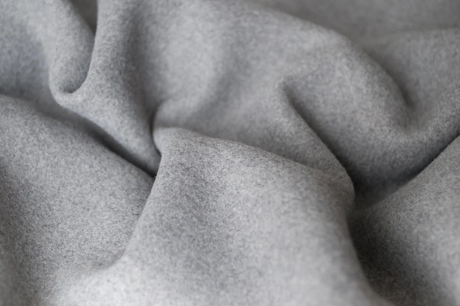 Close up of natural wool fabric texture with soft fibrous surface