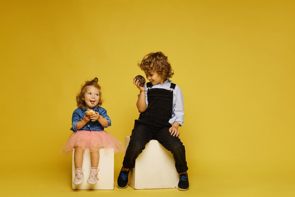 Colorful display of 2025 toddler fashion trends including bright colors, sustainable materials, and modern designs