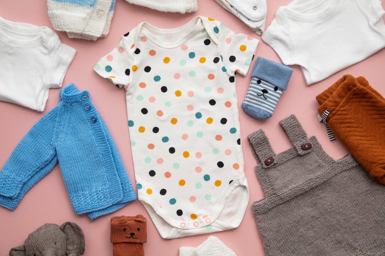 Essential toddler clothing items laid out including t-shirts, pants, and basic wardrobe pieces