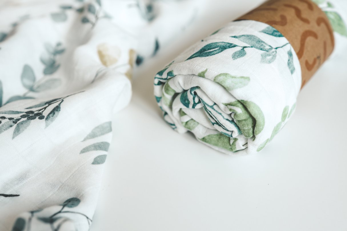 Parent holding baby clothes showing different fabric types and sizing considerations for choosing the right baby clothing