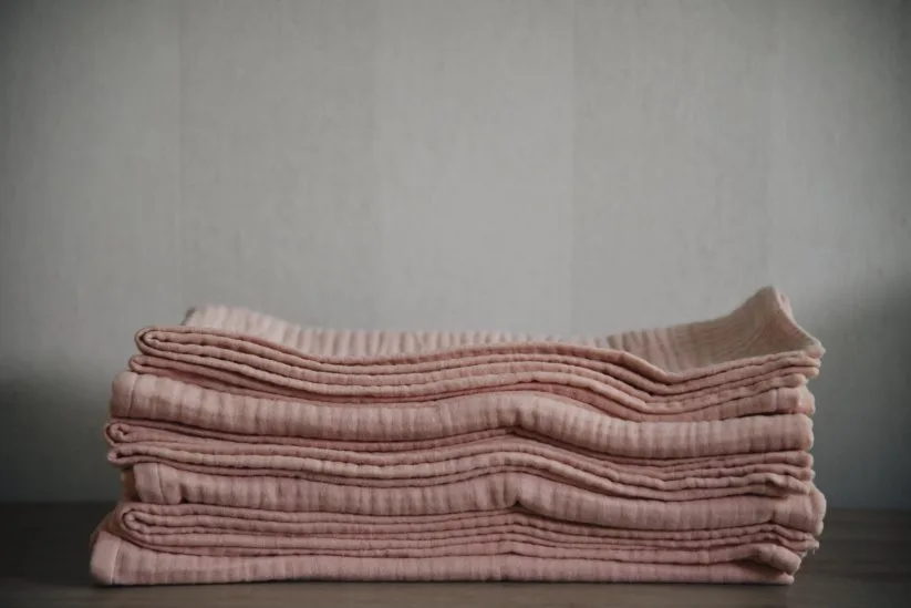 Comparison of different fabric types for preemie clothing including organic cotton, bamboo, and cotton blends with texture examples