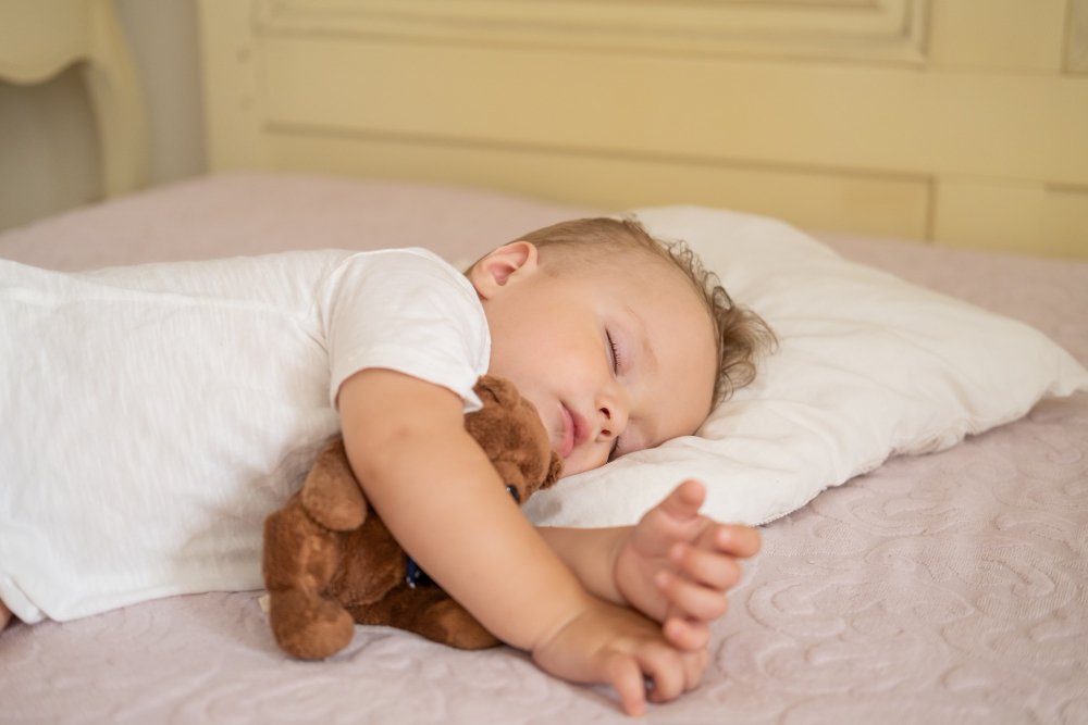 Baby nursery setup for summer showing lightweight sleep sack, room thermometer, and proper ventilation