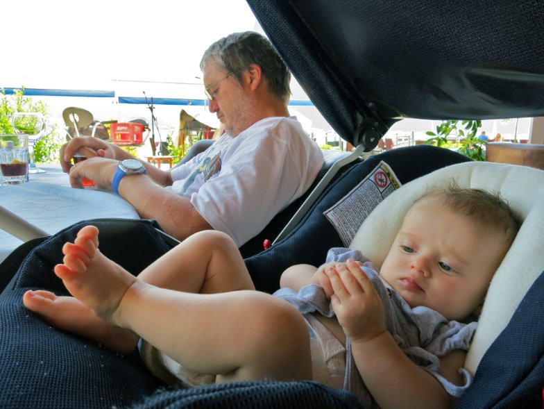 Car with sunshades on windows and properly ventilated car seat setup for safe summer travel with newborn