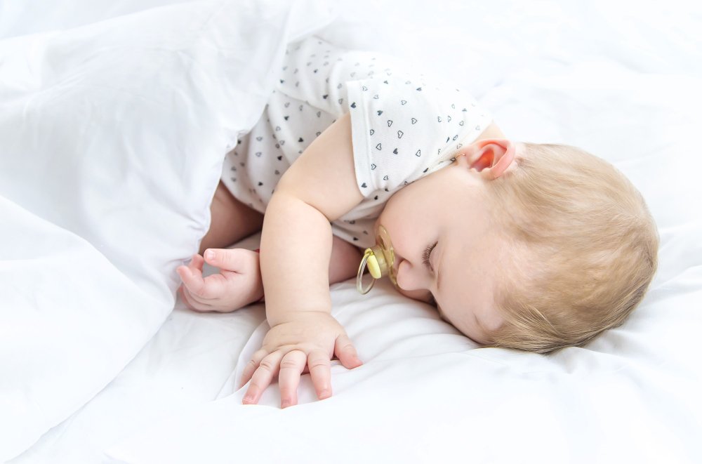 Peaceful sleeping newborn baby demonstrating healthy sleep patterns