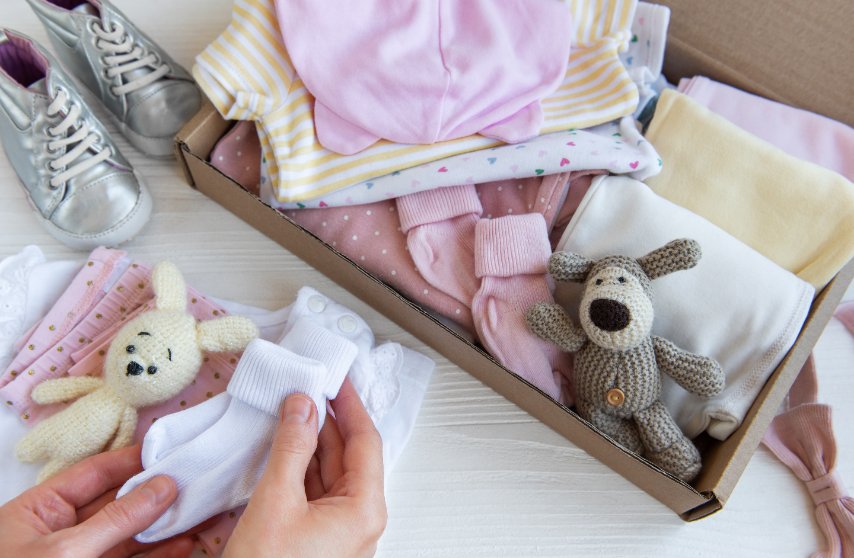Collection of baby clothes in various sizes showing what hand-me-down clothes look like