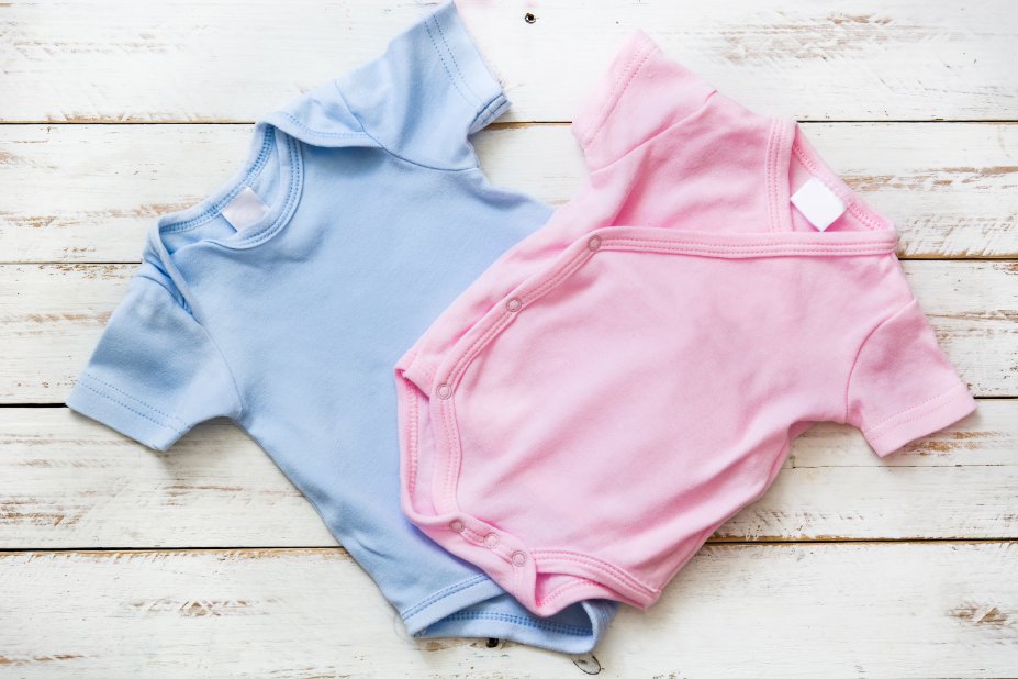Various types of preemie clothing including bodysuits, gowns, sleep sacks, and swaddles arranged to show different styles and sizes