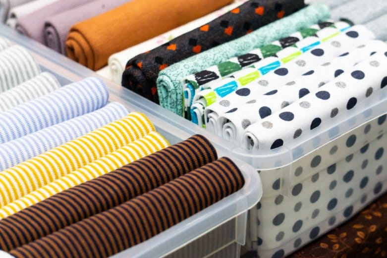 Various pieces of fabric for sewing organised in a storage