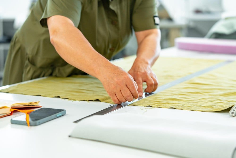 Seamstress preparing a fabric for cutting