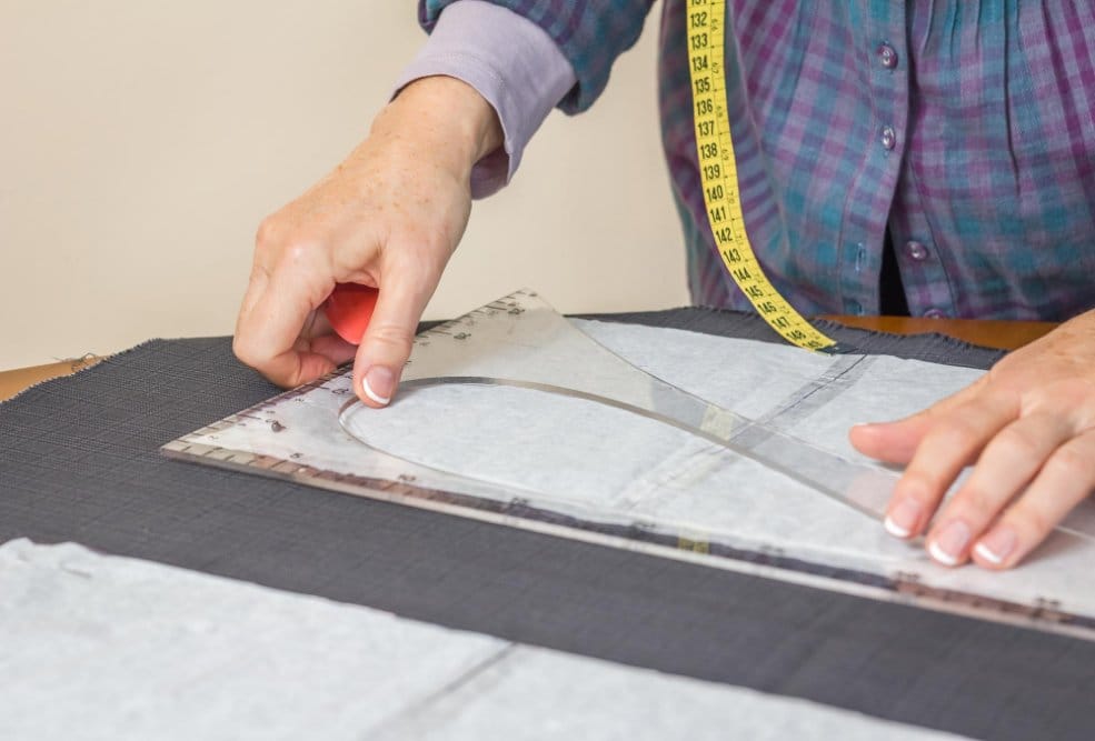 A seamstress measuring a fabric for accurate cutting