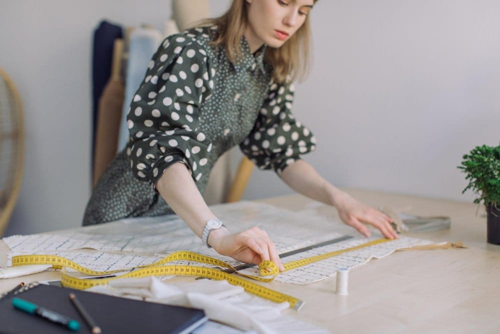A seamstress checking to make sure fabric is accurately measured and cut