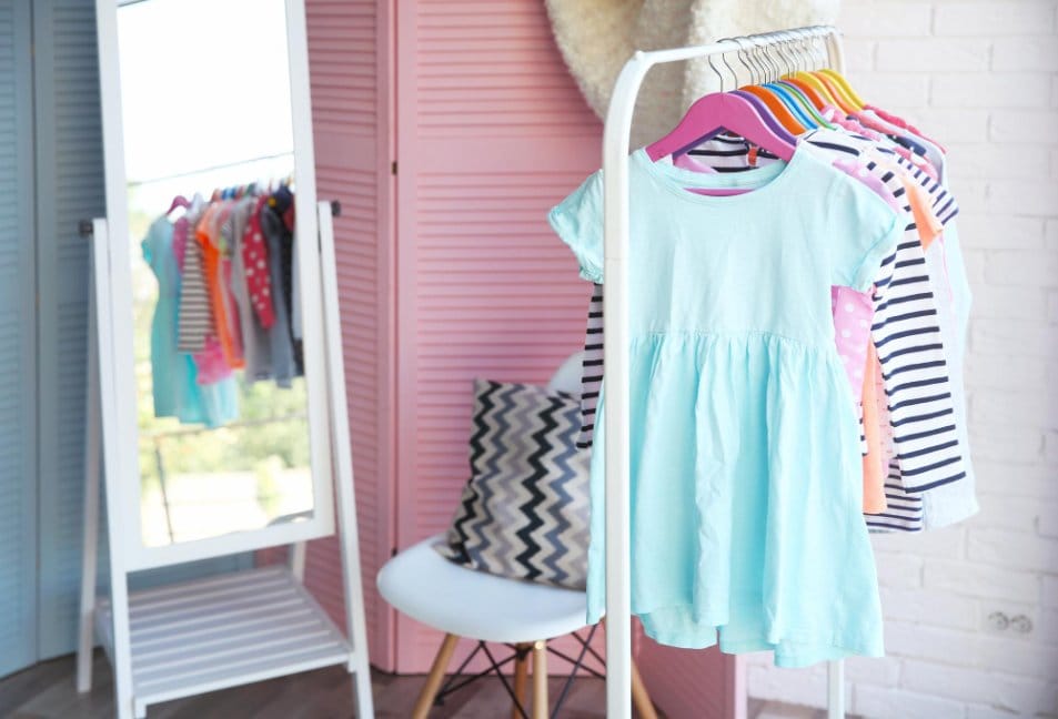 toddler clothes hung on a clothing rack