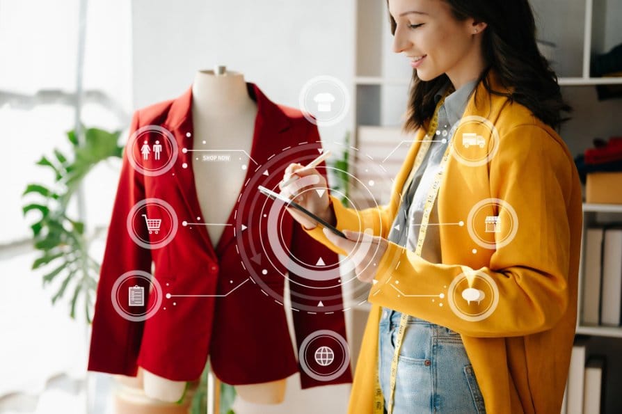 Woman typing on her tablet making a note, and of a coat with virtual icons on display