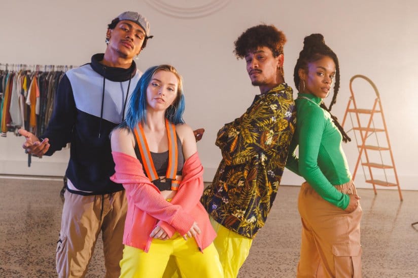 A diverse group of young adults posing in front of a camera showcasing different fashion styles and trends for 2025