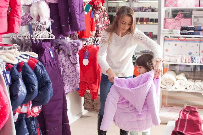 Toddler wearing layered clothing showing seasonal adaptability with light jacket over shirt and comfortable pants
