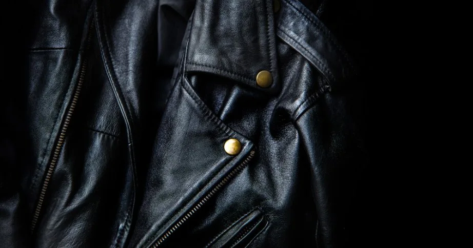 Close up of black leather jacket texture highlighting grain and hardware