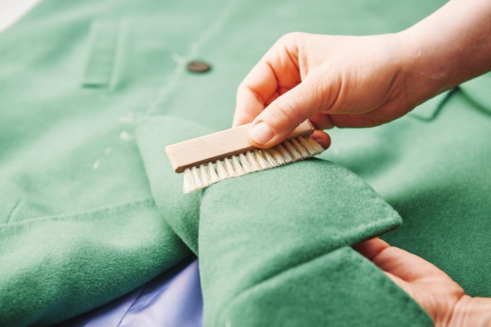 A woman brushing a suede coat