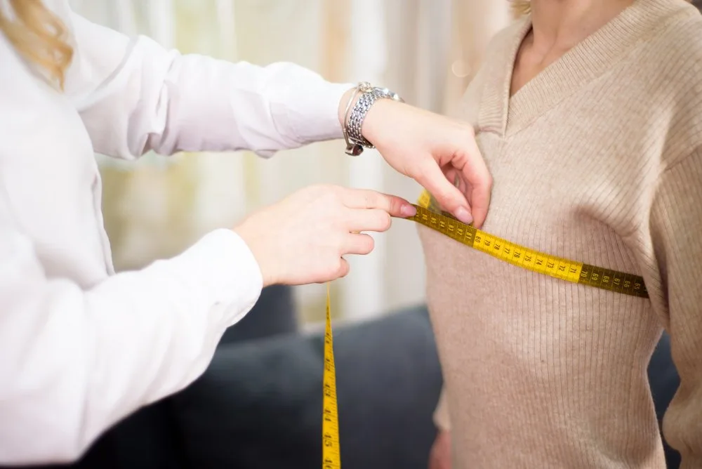 Visual guide showing proper sweater fit measurements and sizing tips