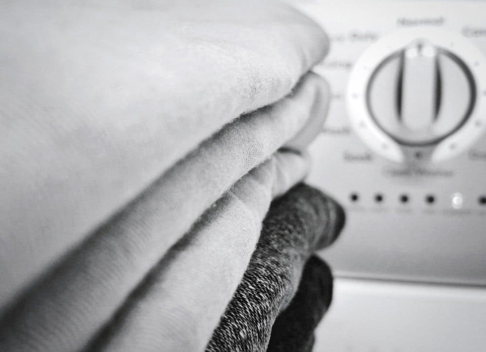 Close photo-shot clothes stacked and washing machine settings