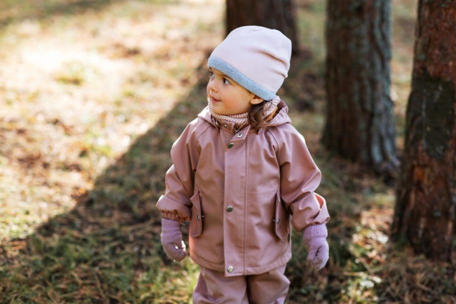 Toddler wearing warm outfit in a cold park