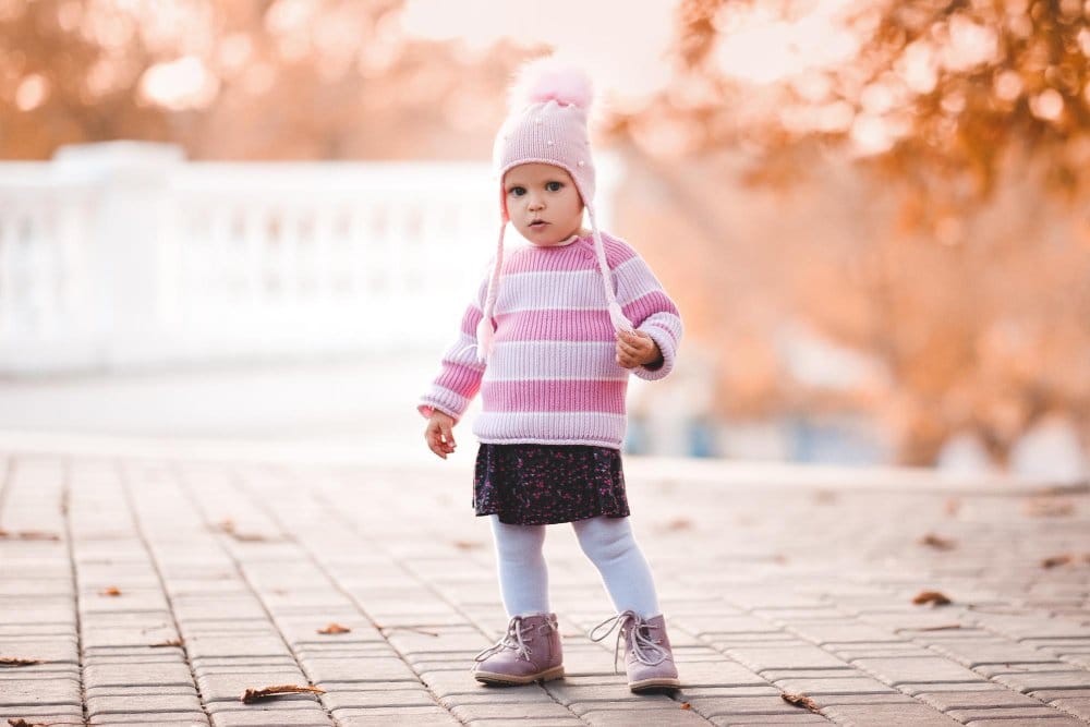 Little girl wearing layered outfit posing for a photo
