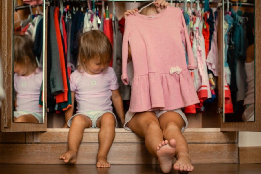 Mom and toddler in the closet choosing clothes