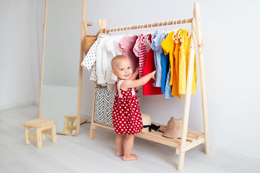 Toddler girl standing near in front of a wardrobe