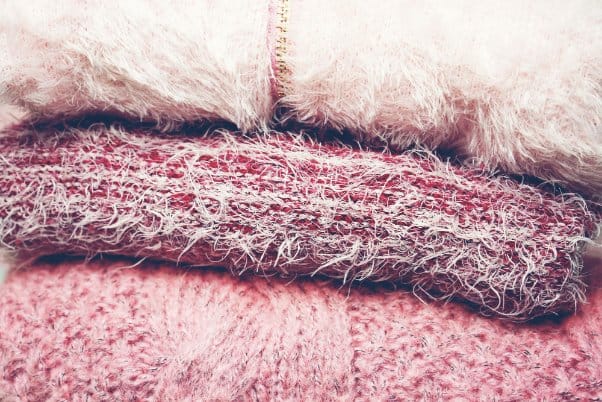 stack of women's sweaters and cardigans made with different materials
