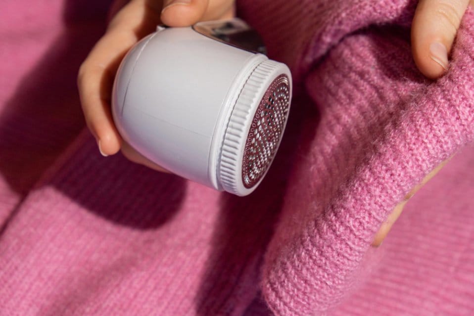 A sweater being maintained using a fabric shaver