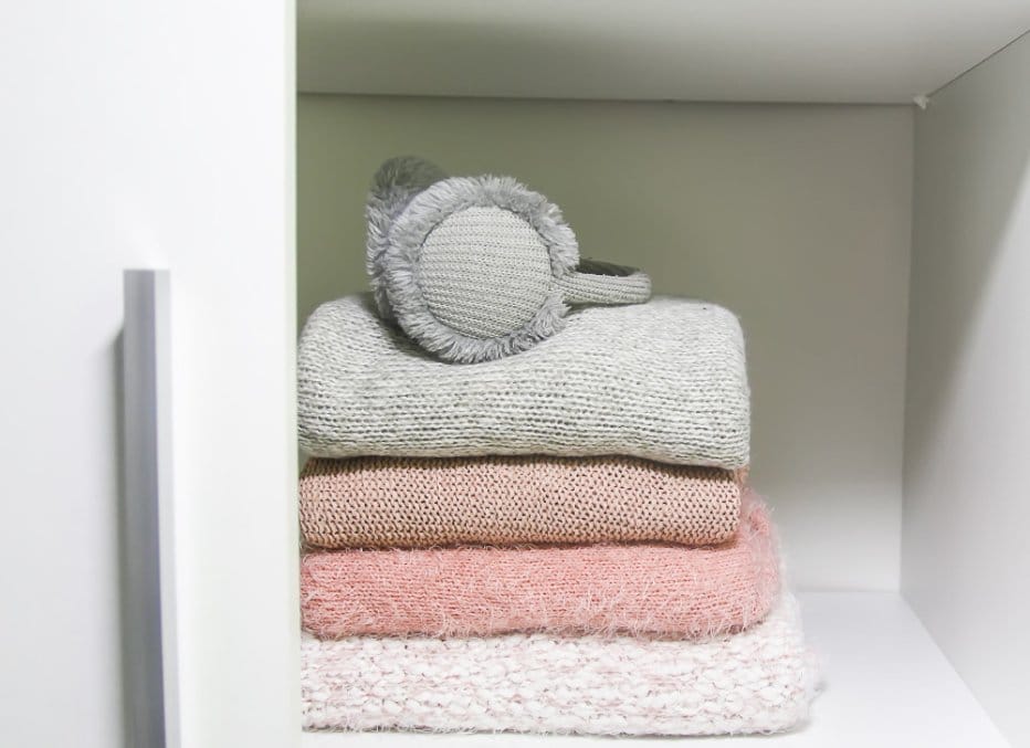 A wardrobe with cashmere sweaters stored in it