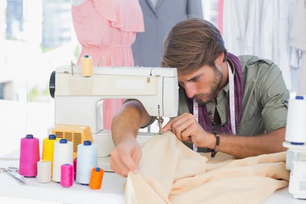 fashion designer sewing a hem