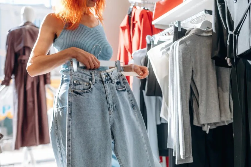 Shopping guide showing different pants and trousers options in a retail setting with price tags and styling advice