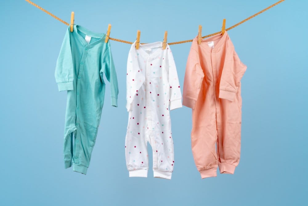 Baby sleepers hung on a clothing line