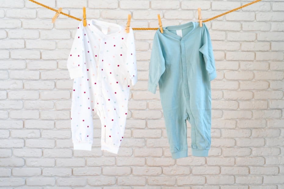 Two baby sleepers hung on a line