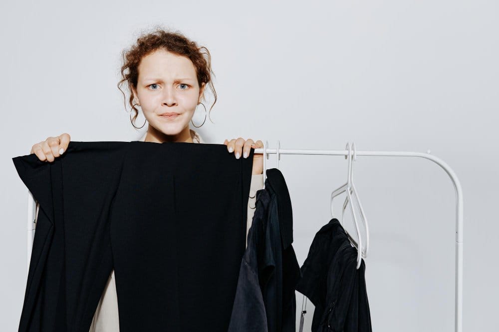 A woman holding a black clothe