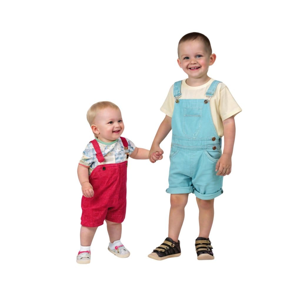 Two young children of different sizes wearing colorful overalls